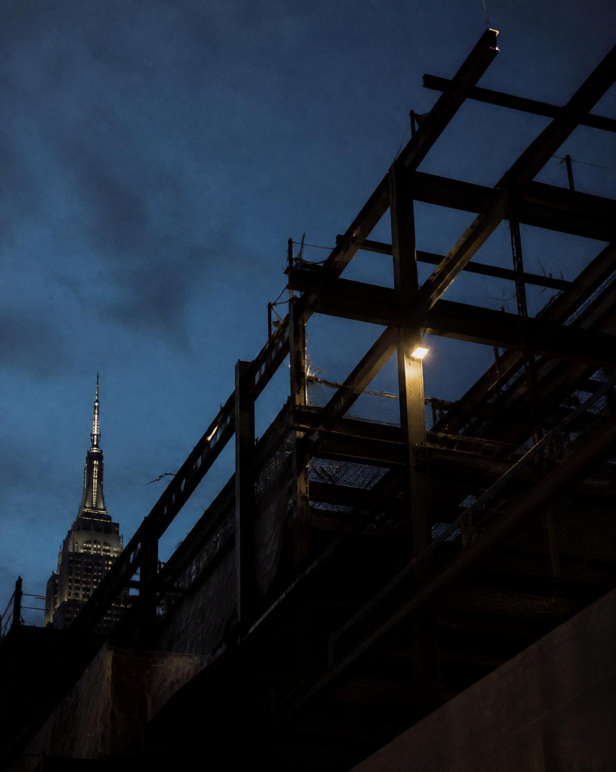 New York construction site framed in steel at dusk